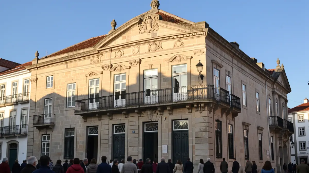 Facade of a municipal building in Nisa, Portugal, with architectural details and sunlight.