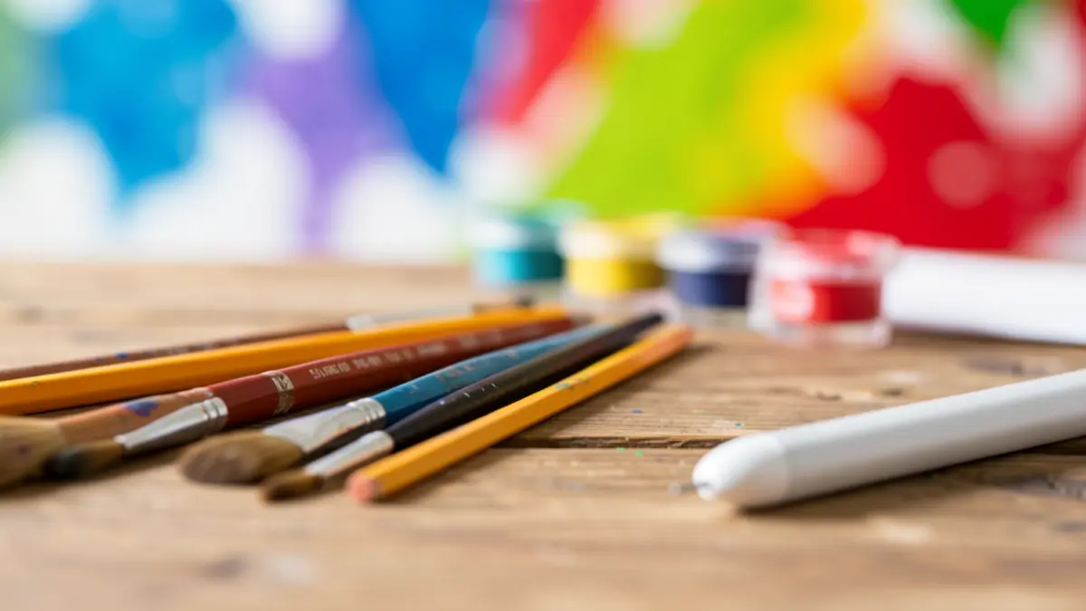 Generic image of artistic tools on a wooden table.