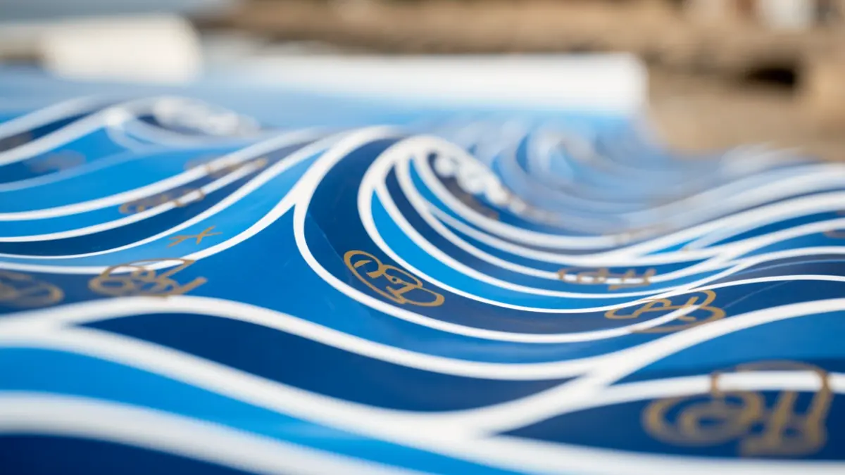 Generic image of a blue and white wave pattern with integrated golden grant symbols, representing the blue economy and funding.