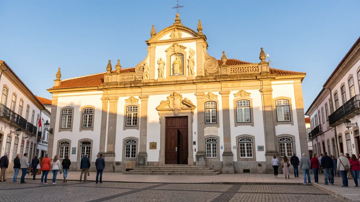 Generic image of a municipal building facade in Portugal, with afternoon sunlight and a blue sky.