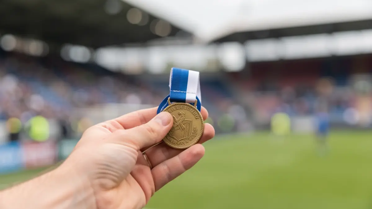 Generic image of a sports medal with a blue and white ribbon, in soft focus.